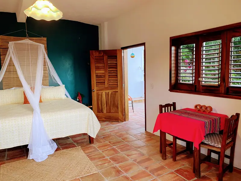 Bedroom with a small table by the door, Casa Gratitud, Yelapa
